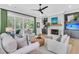 Inviting living room with fireplace, ceiling fan and access to an outdoor patio at 7878 Gull Bay Dr, Awendaw, SC 29429