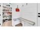 Bright mudroom with white shiplap walls, seating, storage, and access to a walk-in pantry at 7878 Gull Bay Dr, Awendaw, SC 29429