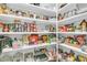Well-organized walk-in pantry featuring white shelving and ample storage for food and kitchen supplies at 7878 Gull Bay Dr, Awendaw, SC 29429