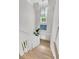 Bright staircase with white railings and light wood floors leading to a well-lit upper level at 7878 Gull Bay Dr, Awendaw, SC 29429