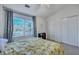 Bright bedroom with a yellow floral comforter, desk, and natural light from a large window at 7963 Shadow Oak Dr, North Charleston, SC 29406