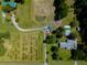 A captivating aerial view showcasing agricultural setting, buildings and small pond at 806 Appii Rd, Moncks Corner, SC 29461