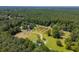 Expansive aerial view of lush, wooded property with a pond, orchard, and various buildings adding to its charm at 806 Appii Rd, Moncks Corner, SC 29461