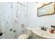 Compact bathroom featuring a shower with a floral curtain, white sink, and white toilet at 806 Appii Rd, Moncks Corner, SC 29461
