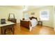 Bright bedroom with wood floors, neutral walls, a classic vanity, and ample natural light at 806 Appii Rd, Moncks Corner, SC 29461