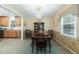 Dining room features wallpaper, wood floors, a crystal chandelier, and an adjacent modern kitchen at 806 Appii Rd, Moncks Corner, SC 29461