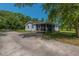 Rear view of home featuring a screened porch and driveway at 806 Appii Rd, Moncks Corner, SC 29461