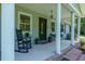 Charming front porch with a rocking chair, potted plants, and elegant columns framing a welcoming entrance at 806 Appii Rd, Moncks Corner, SC 29461