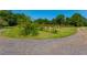 Well-maintained yard featuring gravel drive, landscaping and a row of bee hives at 806 Appii Rd, Moncks Corner, SC 29461