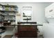 Laundry room with a sink, dark countertops, open shelving, and stacked washer and dryer at 806 Appii Rd, Moncks Corner, SC 29461
