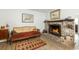Cozy living room with a brick fireplace, decorative seating, and warm lighting at 806 Appii Rd, Moncks Corner, SC 29461