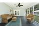 Inviting screened porch with wicker furniture, ceiling fan, and serene outdoor views at 806 Appii Rd, Moncks Corner, SC 29461