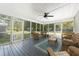 Relaxing screened porch featuring wicker furniture, ceiling fan and view of landscaped yard at 806 Appii Rd, Moncks Corner, SC 29461