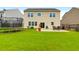 Expansive backyard features a patio with outdoor furniture, a grill, and a green lawn at 9785 Black Willow Ln, Ladson, SC 29456