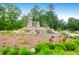 Stunning community entrance with a water feature, lush landscaping, and welcoming signage at 9785 Black Willow Ln, Ladson, SC 29456