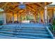 Inside the lodge, there are picnic tables and there is a view of the community pool from the lodge at 9785 Black Willow Ln, Ladson, SC 29456