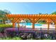 Inviting community pool area with pergola, lounge chairs, and tables, perfect for relaxation and social gatherings at 9785 Black Willow Ln, Ladson, SC 29456