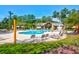 Beautiful community pool surrounded by lush landscaping, featuring lounge chairs and umbrellas for a relaxing experience at 9785 Black Willow Ln, Ladson, SC 29456