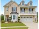 Charming two-story home with landscaped yard, covered porch, and three dormer windows at 9785 Black Willow Ln, Ladson, SC 29456