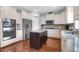 Well-lit kitchen with stainless steel appliances, granite counters, and an island at 9785 Black Willow Ln, Ladson, SC 29456
