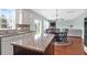 Open kitchen area with stainless steel appliances, island, and connected breakfast nook at 9785 Black Willow Ln, Ladson, SC 29456