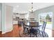 Open-concept space with a kitchen and eat-in area with wood flooring and plenty of light at 9785 Black Willow Ln, Ladson, SC 29456
