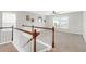 Carpeted upstairs landing with wood and white railing at 9785 Black Willow Ln, Ladson, SC 29456