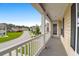 Inviting porch with white railings offering scenic neighborhood views and ample natural light at 9785 Black Willow Ln, Ladson, SC 29456