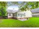 Expansive backyard featuring lush green grass and a cozy patio area perfect for outdoor entertaining at 100 Cheshire Dr, Goose Creek, SC 29445