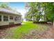 Backyard featuring lush greenery, small storage sheds, and a satellite dish at 100 Cheshire Dr, Goose Creek, SC 29445