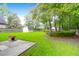 A spacious, grassy backyard features a storage shed and mature trees at 100 Cheshire Dr, Goose Creek, SC 29445