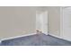 Neutral-toned bedroom featuring two doorways and a large window at 100 Cheshire Dr, Goose Creek, SC 29445