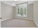 Well-lit bedroom features large window, providing natural light and view of surrounding scenery at 100 Cheshire Dr, Goose Creek, SC 29445