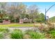Inviting entrance to The Hamlets neighborhood, showcasing manicured landscaping and brick signage at 100 Cheshire Dr, Goose Creek, SC 29445