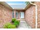 Inviting entryway with brick walls, a white front door, and manicured landscaping at 100 Cheshire Dr, Goose Creek, SC 29445