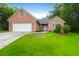 Charming one-story brick home with a well-manicured lawn and attached two-car garage at 100 Cheshire Dr, Goose Creek, SC 29445