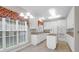 Well-lit kitchen boasts white cabinets, kitchen island with cooktop, and a double oven at 100 Cheshire Dr, Goose Creek, SC 29445