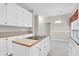 Modern kitchen featuring island cooktop, white cabinets, and tile floors at 100 Cheshire Dr, Goose Creek, SC 29445