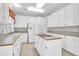 Kitchen features white cabinets, island with cooktop, and tile flooring at 100 Cheshire Dr, Goose Creek, SC 29445