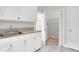 Bright kitchen featuring white cabinetry, ample storage, and an open pantry for convenient organization at 100 Cheshire Dr, Goose Creek, SC 29445