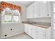Bright laundry room with window, sink, and cabinets at 100 Cheshire Dr, Goose Creek, SC 29445