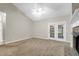 Spacious living room features a brick fireplace, ceiling fan, and backyard access at 100 Cheshire Dr, Goose Creek, SC 29445