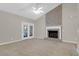 Bright living room with vaulted ceiling, brick fireplace, and glass doors to the outside at 100 Cheshire Dr, Goose Creek, SC 29445