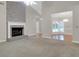 Open living room with fireplace transitions to dining room, enhancing the home's flow at 100 Cheshire Dr, Goose Creek, SC 29445