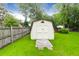 A white storage shed sits within the property's well-maintained, fully fenced backyard at 100 Cheshire Dr, Goose Creek, SC 29445