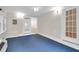 Bright sunroom featuring blue carpet, lots of windows and double doors at 100 Cheshire Dr, Goose Creek, SC 29445