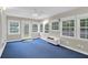 Bright sunroom featuring blue carpet, lots of windows and double doors at 100 Cheshire Dr, Goose Creek, SC 29445