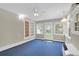 Bright sunroom featuring blue carpet, lots of windows and double doors at 100 Cheshire Dr, Goose Creek, SC 29445