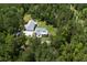 A beautiful aerial view reveals a property that features a home with a lush green lawn and dense, mature trees at 105 Bobcat Ln, Ravenel, SC 29470
