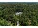 Aerial view of a secluded property surrounded by lush trees and featuring a long driveway to the home at 105 Bobcat Ln, Ravenel, SC 29470